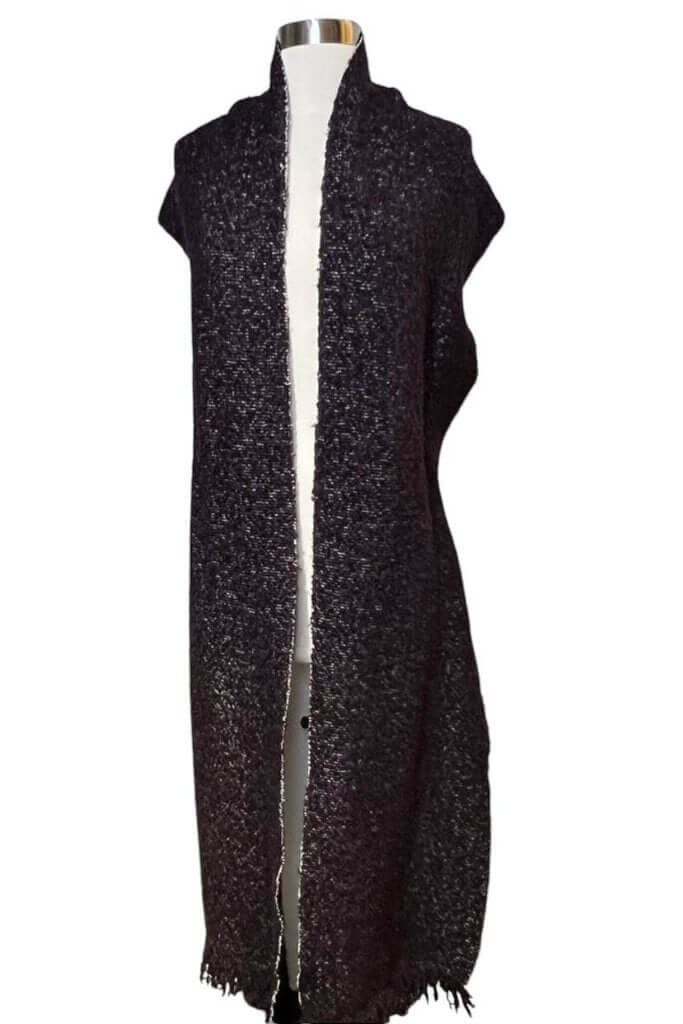 The CHANEL Wool/Cashmere Blend Overcoat with a Detached Scarf is a refined and timeless outerwear piece, combining the warmth of wool and cashmere for ultimate comfort. The detachable scarf adds versatility, allowing for various styling options while maintaining the coat’s sophisticated, elegant silhouette.
