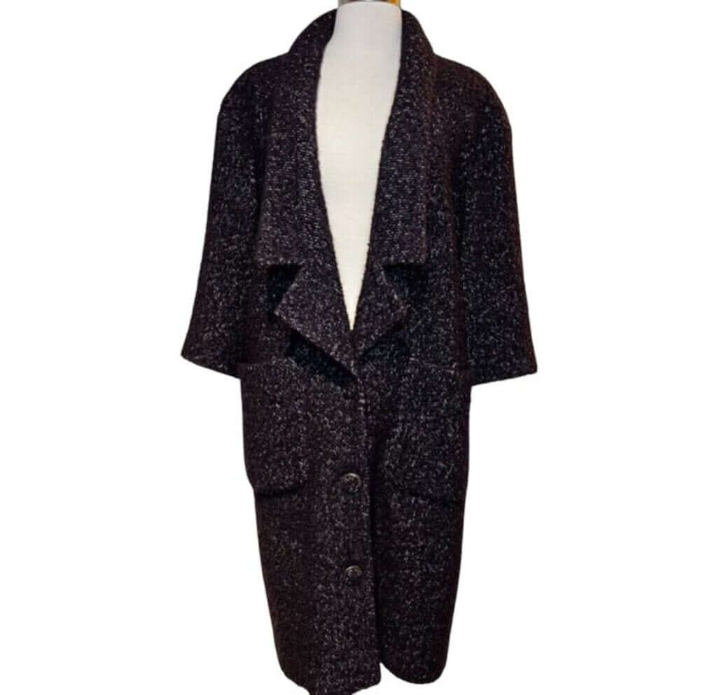 The CHANEL Wool/Cashmere Blend Overcoat with a Detached Scarf is a refined and timeless outerwear piece, combining the warmth of wool and cashmere for ultimate comfort. The detachable scarf adds versatility, allowing for various styling options while maintaining the coat’s sophisticated, elegant silhouette.