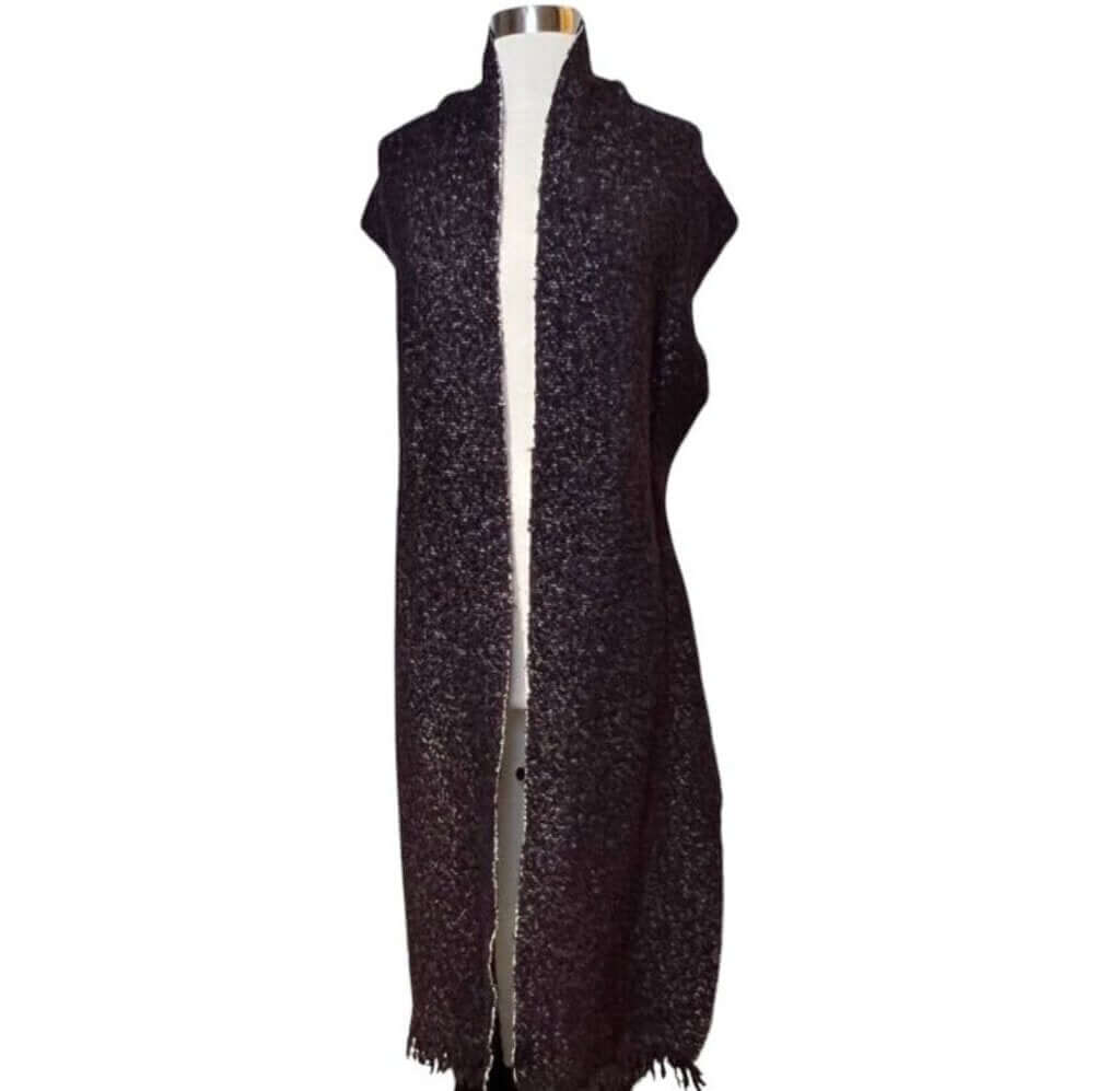 The CHANEL Wool/Cashmere Blend Overcoat with a Detached Scarf is a refined and timeless outerwear piece, combining the warmth of wool and cashmere for ultimate comfort. The detachable scarf adds versatility, allowing for various styling options while maintaining the coat’s sophisticated, elegant silhouette.