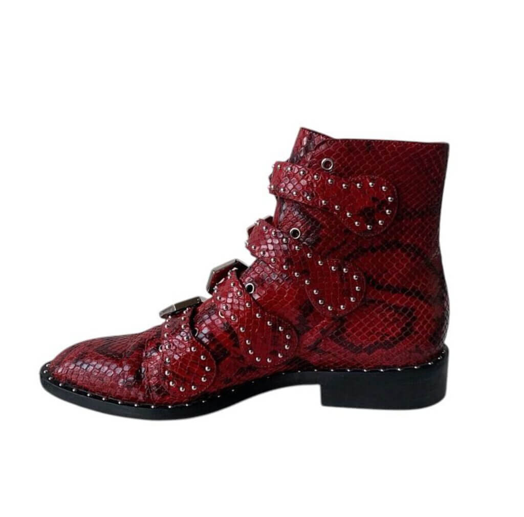 The Givenchy Ankle-High Snake-Embossed Studded Calfskin Boots fuse edgy sophistication with luxurious craftsmanship, featuring a bold snake-embossed leather design and striking studded accents. With their sleek ankle-high silhouette and durable calfskin construction, these boots make a powerful statement, perfect for adding a rebellious yet refined touch to any outfit.