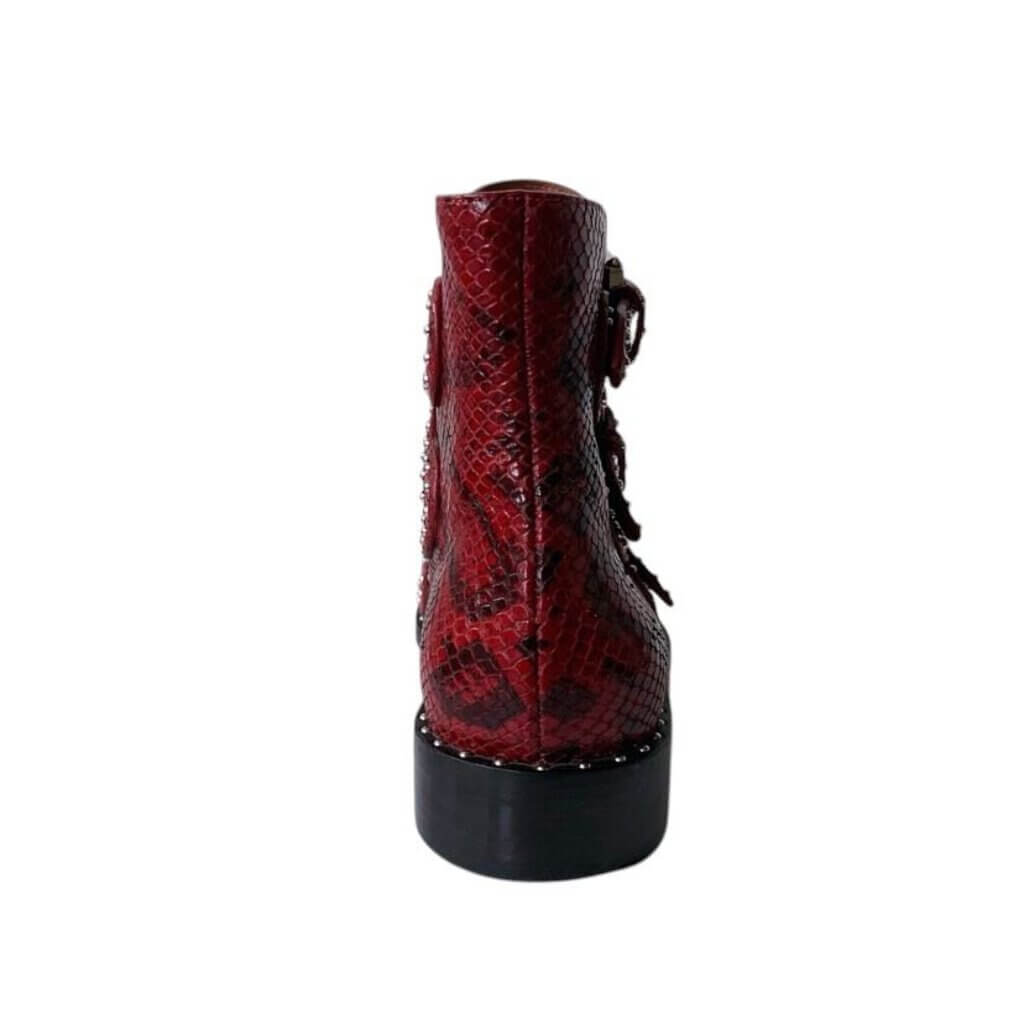 The Givenchy Ankle-High Snake-Embossed Studded Calfskin Boots fuse edgy sophistication with luxurious craftsmanship, featuring a bold snake-embossed leather design and striking studded accents. With their sleek ankle-high silhouette and durable calfskin construction, these boots make a powerful statement, perfect for adding a rebellious yet refined touch to any outfit.