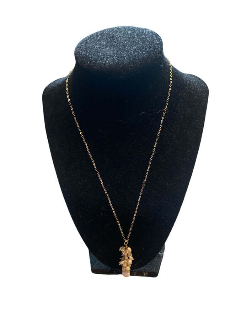 The Ruth Barzel Freshwater Pearls, Labradorite, and Champagne Cubic Zirconia Necklace on a gold-filled chain combines delicate pearls, shimmering labradorite, and sparkling cubic zirconia for a refined, earthy elegance. This luxurious piece adds a touch of sophistication to any ensemble with its timeless design.