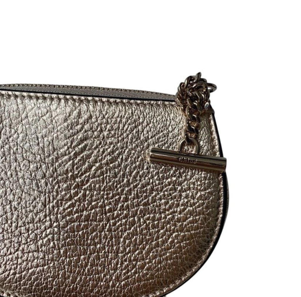 The Chloe Drew Coin Purse is a compact, elegant accessory crafted from luxurious leather, featuring the brand's signature turn-lock closure and a chic, minimalist design. Perfect for carrying essentials or as a stylish addition to a larger bag, this purse combines practicality with the timeless sophistication Chloe is known for.