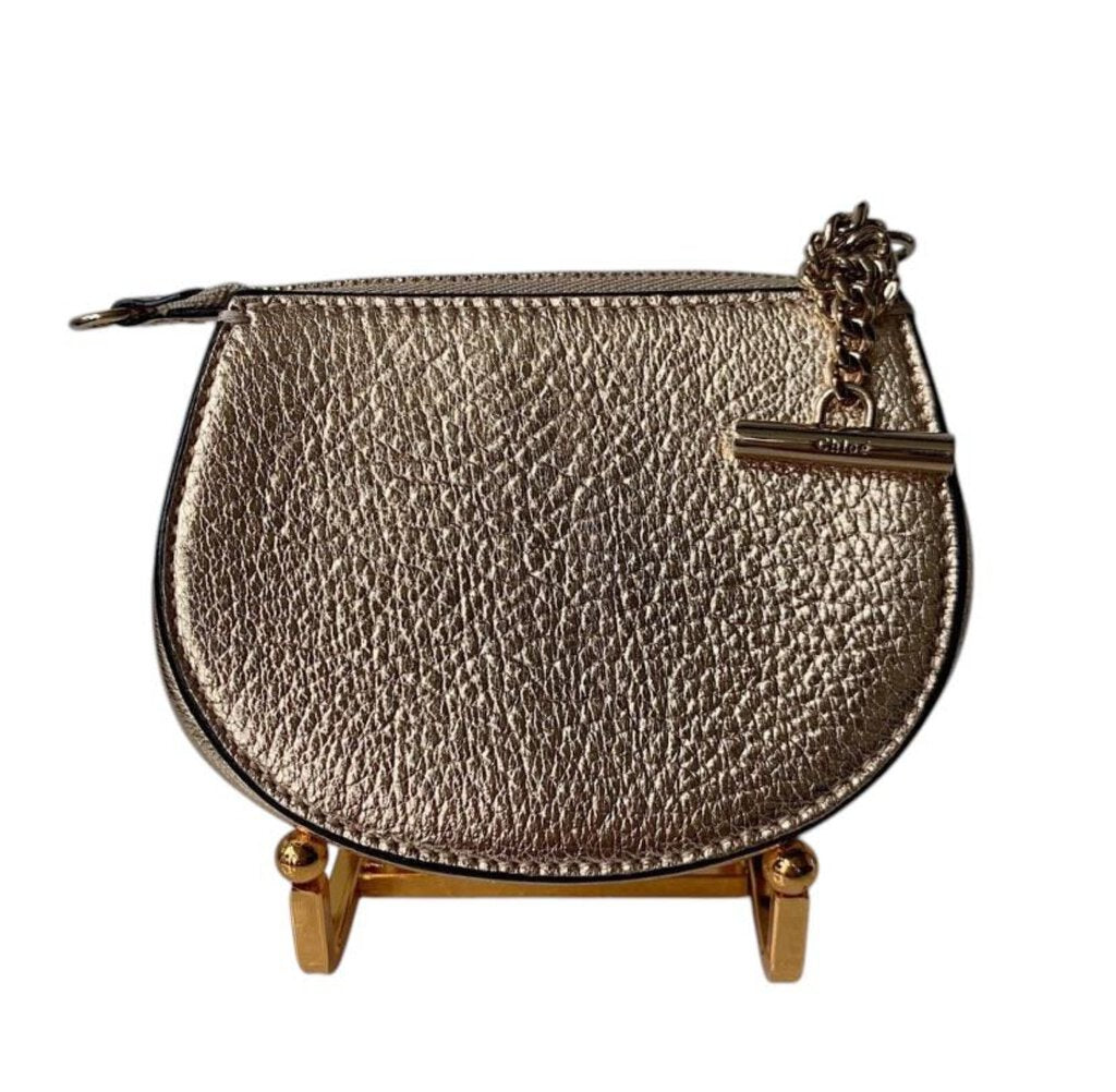 The Chloe Drew Coin Purse is a compact, elegant accessory crafted from luxurious leather, featuring the brand's signature turn-lock closure and a chic, minimalist design. Perfect for carrying essentials or as a stylish addition to a larger bag, this purse combines practicality with the timeless sophistication Chloe is known for.