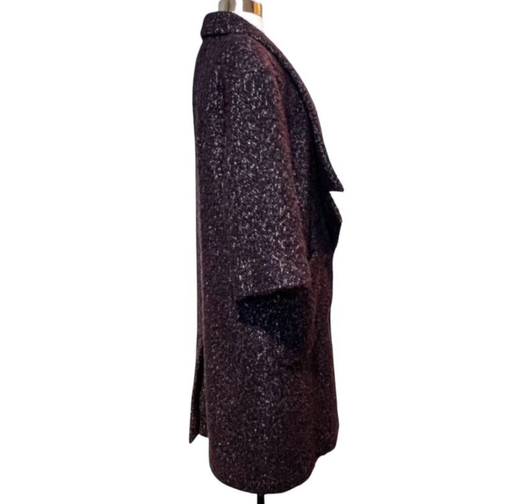 The CHANEL Wool/Cashmere Blend Overcoat with Detached Scarf combines luxurious warmth and elegance, crafted from a rich wool-cashmere blend for a soft, refined feel. The detachable scarf adds versatility and style, making it a sophisticated outerwear piece that effortlessly elevates any winter wardrobe.