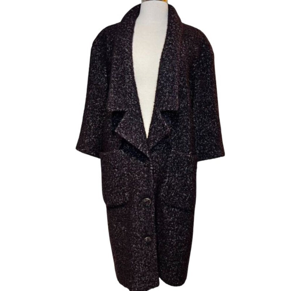 The CHANEL Wool/Cashmere Blend Overcoat with Detached Scarf combines luxurious warmth and elegance, crafted from a rich wool-cashmere blend for a soft, refined feel. The detachable scarf adds versatility and style, making it a sophisticated outerwear piece that effortlessly elevates any winter wardrobe.