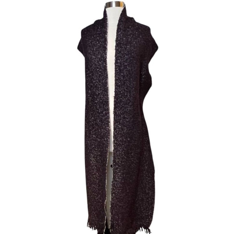 The CHANEL Wool/Cashmere Blend Overcoat with Detached Scarf combines luxurious warmth and elegance, crafted from a rich wool-cashmere blend for a soft, refined feel. The detachable scarf adds versatility and style, making it a sophisticated outerwear piece that effortlessly elevates any winter wardrobe.