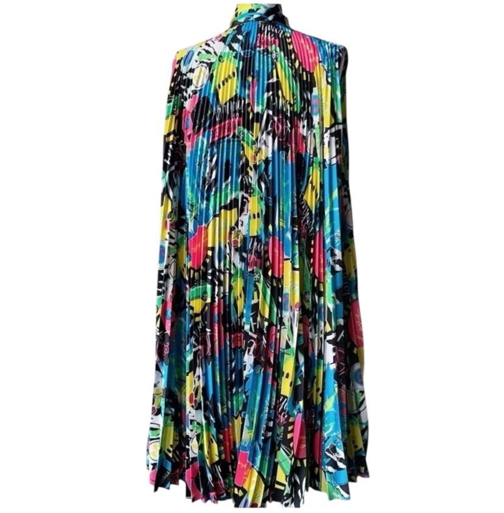 The Balenciaga Sleeveless Knife Pleated Graphic Pop Print Dress is a bold, statement-making piece that combines intricate knife pleats with vibrant, eye-catching graphic prints. Its modern silhouette and dynamic design create a perfect balance of art and fashion, making it a standout choice for those seeking to make a fashionable impact.