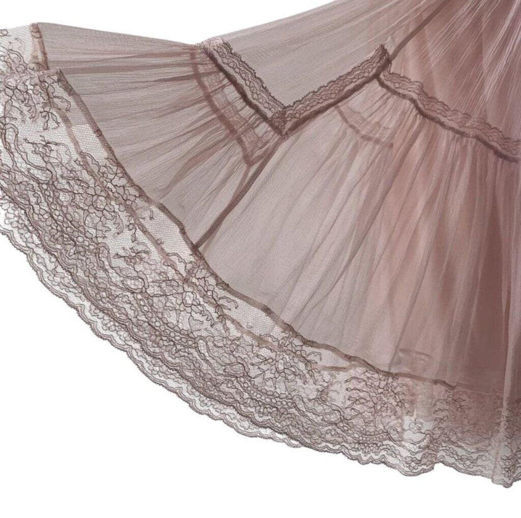 The Christian Dior Silk Chiffon Skirt is a luxurious, ethereal piece crafted from lightweight, flowing silk chiffon that drapes beautifully on the body. With its delicate, soft texture and timeless silhouette, this skirt exudes refined elegance and feminine grace, perfect for both formal occasions and sophisticated everyday wear.