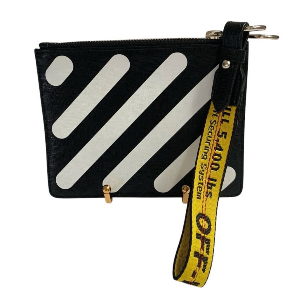 The Off-White Graphic Print Double Zip Clutch combines streetwear flair with high-fashion appeal, featuring bold graphic prints and the brand's signature industrial detailing. With two zip compartments for easy organization, this clutch offers both practicality and an edgy, artistic touch, perfect for adding a statement to any outfit.