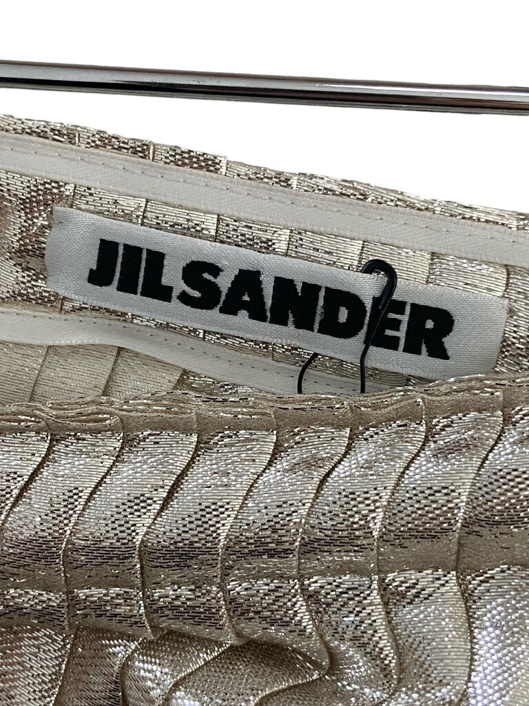 The Jil Sander Knife Pleated Shimmer Skirt is an exquisite blend of elegance and contemporary style, featuring delicate knife pleats that catch the light beautifully. Its shimmering fabric adds a touch of sophistication, making it a perfect choice for both day and evening wear.