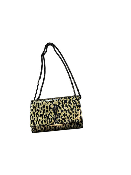 The YSL Patent Glitter Cheetah Bag is a striking accessory that combines luxurious patent leather with a playful cheetah print, exuding bold sophistication. Its shimmering finish and iconic YSL logo make it a standout piece for any fashion-forward ensemble.