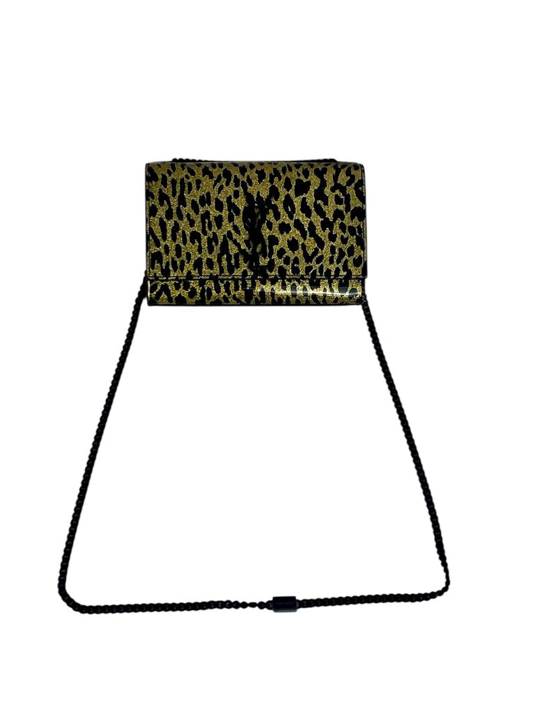 The YSL Patent Glitter Cheetah Bag is a striking accessory that combines luxurious patent leather with a playful cheetah print, exuding bold sophistication. Its shimmering finish and iconic YSL logo make it a standout piece for any fashion-forward ensemble.