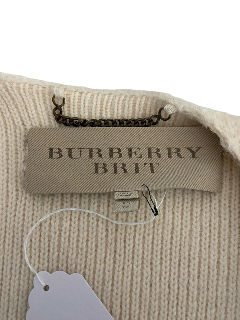 The Burberry Brit Wool Blend Sweater Coat is a stylish and cozy outerwear piece, crafted from a luxurious wool blend for warmth and comfort. Its relaxed fit and versatile design make it perfect for layering over various outfits, adding a touch of sophisticated elegance to any look.