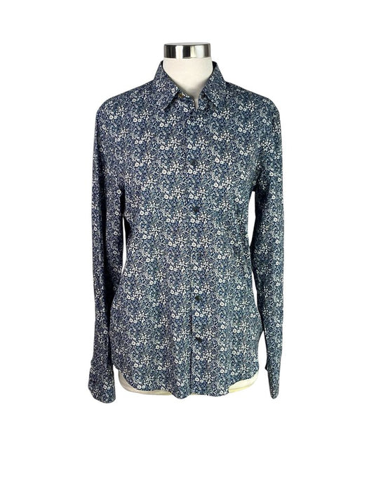 The Paul Smith Floral Button Down Shirt features a vibrant floral print that adds a lively touch to a classic silhouette. Crafted from high-quality fabric, this shirt is perfect for both casual and formal occasions, effortlessly blending style and sophistication.