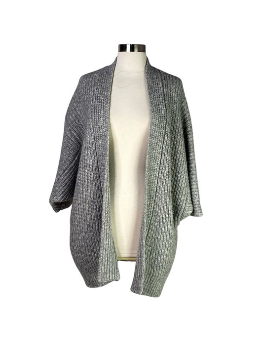 The Nili Lotan Chunky Knit Alpaca Blend Cardigan is a luxurious, oversized piece made from a soft alpaca blend, offering both warmth and a relaxed, stylish silhouette. With its textured knit and versatile design, it’s the perfect layer to elevate any casual or cozy ensemble.