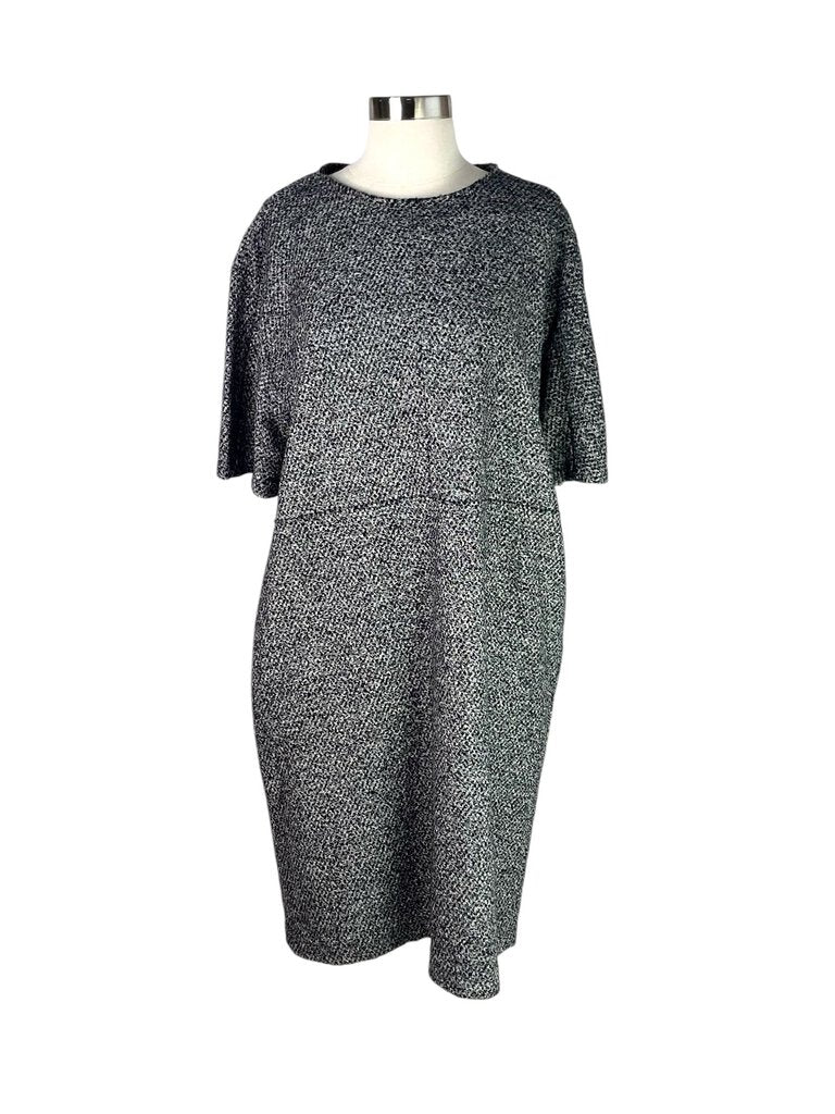 The Jil Sander Textured Dress is an elegant and minimalist piece, featuring a unique textured fabric that adds depth and interest to its sleek silhouette. With its refined design and versatile style, this dress is perfect for both casual outings and more formal occasions.