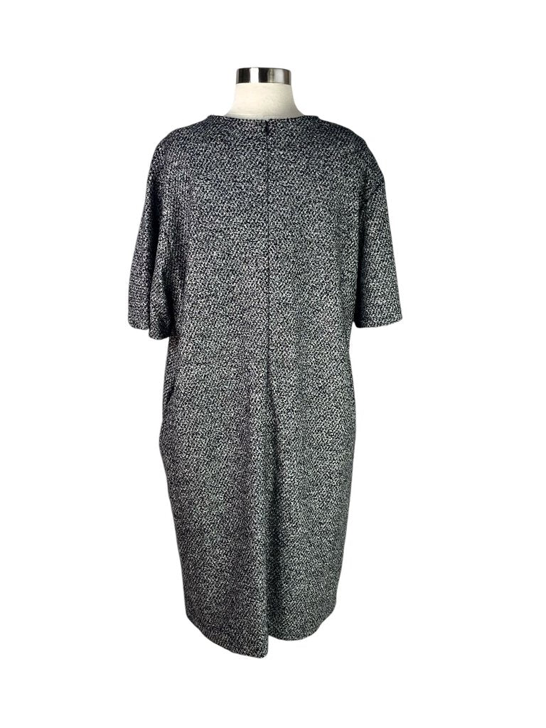 The Jil Sander Textured Dress is an elegant and minimalist piece, featuring a unique textured fabric that adds depth and interest to its sleek silhouette. With its refined design and versatile style, this dress is perfect for both casual outings and more formal occasions.