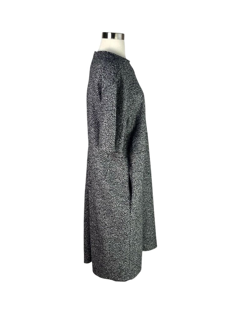 The Jil Sander Textured Dress is an elegant and minimalist piece, featuring a unique textured fabric that adds depth and interest to its sleek silhouette. With its refined design and versatile style, this dress is perfect for both casual outings and more formal occasions.