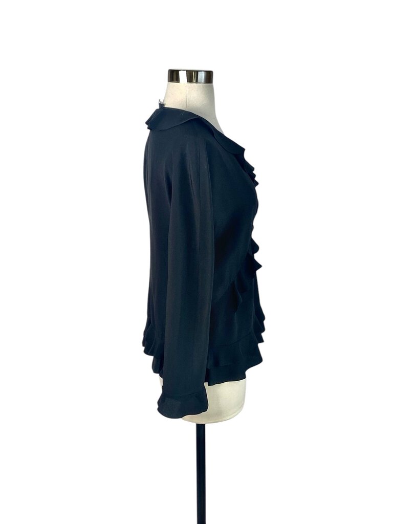 The Gucci Silk Ruffle V-Neck Blouse is an exquisite piece that exudes elegance, featuring a delicate ruffle detail along the neckline for a touch of femininity. Crafted from luxurious silk, this blouse drapes beautifully and pairs effortlessly with both tailored and casual looks, making it a versatile addition to any wardrobe.