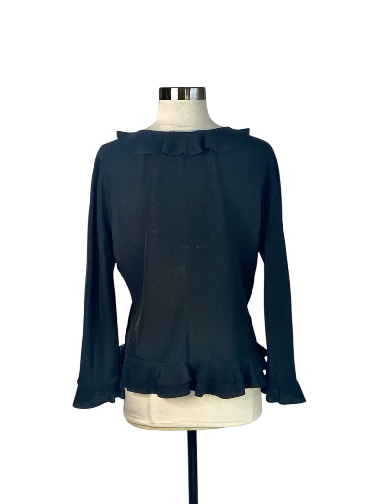 The Gucci Silk Ruffle V-Neck Blouse is an exquisite piece that exudes elegance, featuring a delicate ruffle detail along the neckline for a touch of femininity. Crafted from luxurious silk, this blouse drapes beautifully and pairs effortlessly with both tailored and casual looks, making it a versatile addition to any wardrobe.