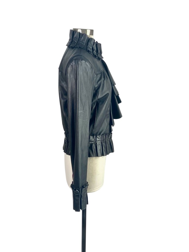 The Diane Von Furstenberg Leather Ruffle Front Zip Jacket is a striking statement piece that combines edgy leather with feminine ruffle detailing. Its tailored fit and unique design make it perfect for adding a bold touch to any outfit, whether casual or more polished.