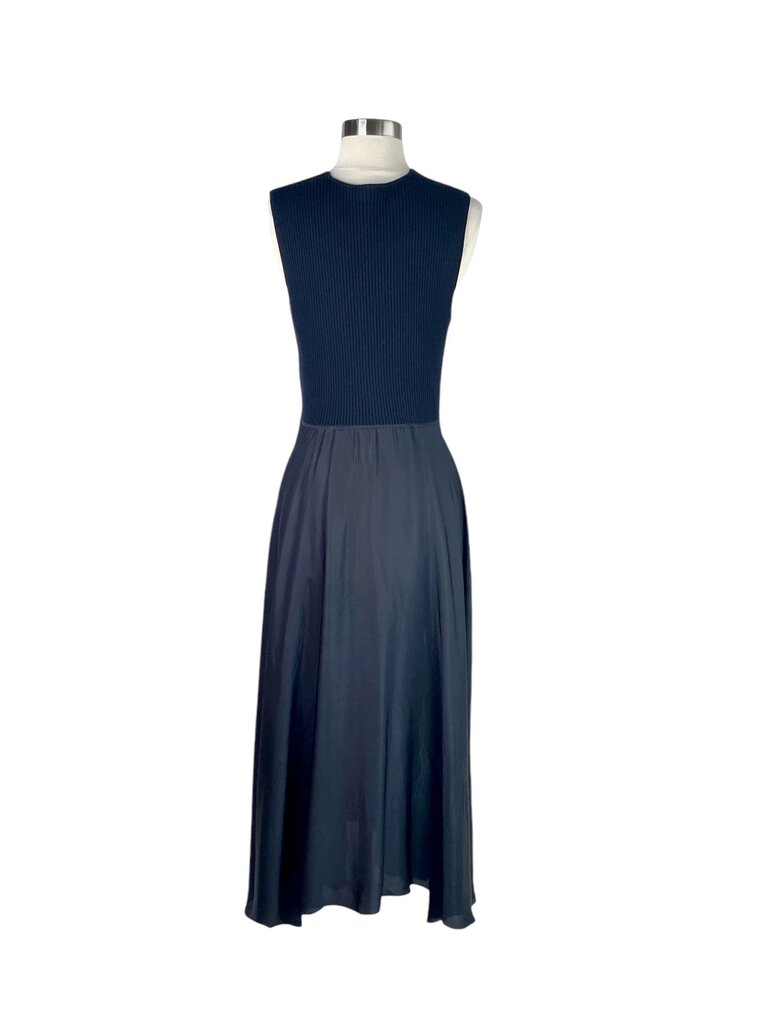 The Theory Mixed Media Surplice Maxi Dress is an effortlessly chic piece that combines soft fabrics with a sleek silhouette, featuring a flattering surplice neckline. Its maxi length and versatile design make it perfect for both casual outings and more formal occasions, offering comfort without compromising on style.