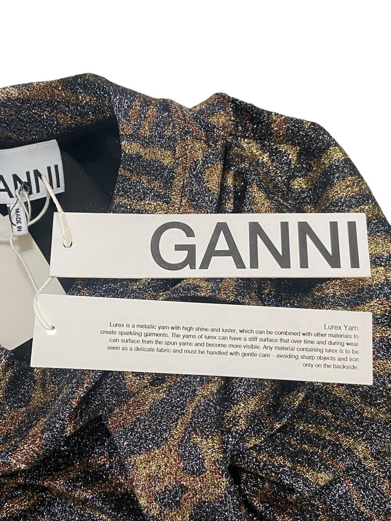 The Ganni Lurex Tiger Print Stretch Top is a bold, statement-making piece that combines shimmering lurex fabric with an eye-catching tiger print for a fierce yet elegant look. Its form-fitting design and stretchy material offer comfort while adding a touch of wild sophistication to any outfit.