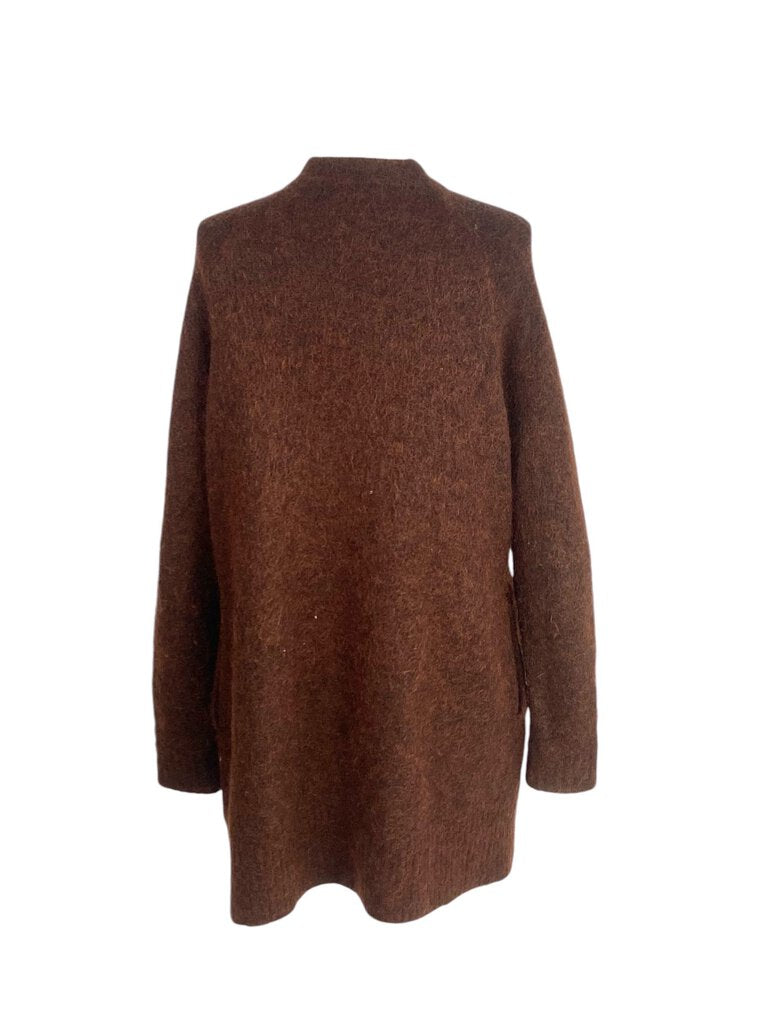 The Acne Studios Mohair Open Front Cardigan is a luxurious and cozy piece, crafted from soft mohair for ultimate warmth and comfort. Its open front design and relaxed silhouette make it perfect for layering, adding a touch of effortless chic to any outfit.