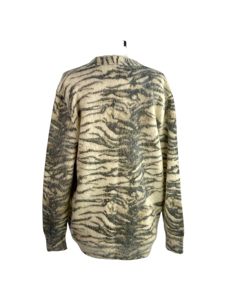 The Saint Laurent Zebra Mohair Cardigan is a luxurious and eye-catching piece, featuring a bold zebra print crafted from soft, cozy mohair. Its relaxed fit and chic design make it a standout choice for layering, effortlessly elevating any casual or sophisticated look.