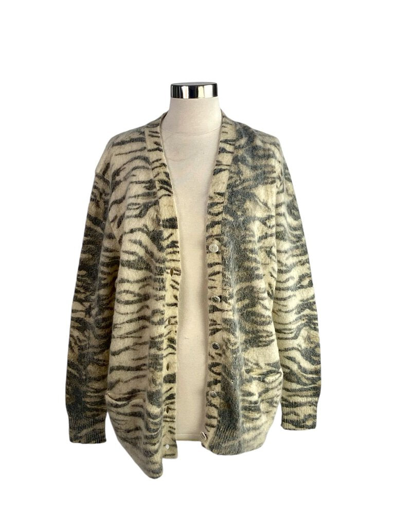 The Saint Laurent Zebra Mohair Cardigan is a luxurious and eye-catching piece, featuring a bold zebra print crafted from soft, cozy mohair. Its relaxed fit and chic design make it a standout choice for layering, effortlessly elevating any casual or sophisticated look.