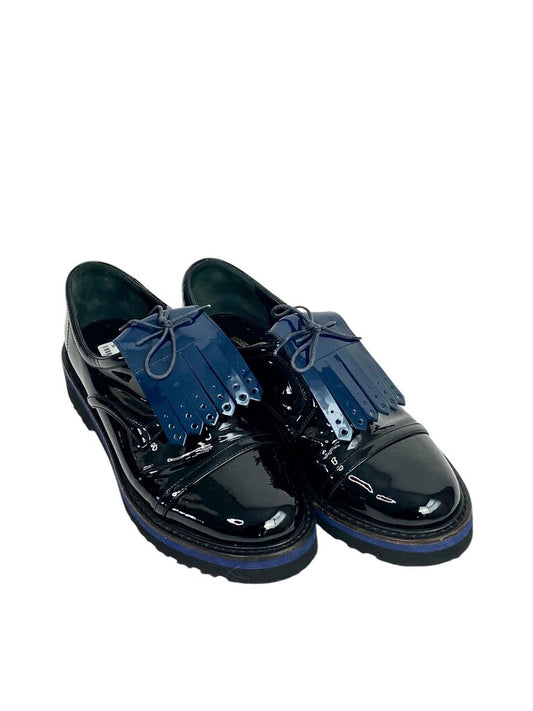 The Nicholas Kirkwood Patent Color Block Loafers are a striking blend of classic and contemporary style, featuring a sleek patent finish and bold color blocking. With their chic design and comfortable fit, these loafers add a fashionable touch to both casual and tailored looks.