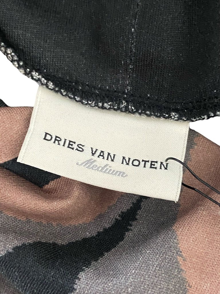 The Dries Van Noten Graphic Print Cotton Turtleneck is a bold and artistic statement piece, showcasing eye-catching graphics on soft cotton fabric. Its fitted turtleneck design offers both comfort and style, making it a versatile addition to any wardrobe, perfect for layering or wearing on its own.