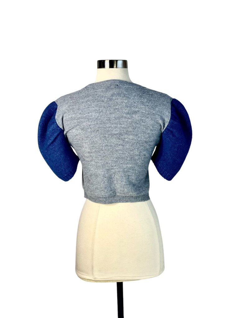 The Rachel Comey Puff Sleeve Color Block Sweater is a striking piece that blends comfort with modern design, featuring playful puff sleeves and a vibrant color block pattern. Crafted from soft materials, it offers a relaxed fit, making it perfect for elevating your casual look with a touch of artistic flair.