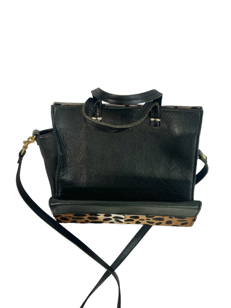 The Clare V Pieced Leopard Crossbody Bag is a striking accessory that combines different textures and prints for a playful yet sophisticated look. Its adjustable strap and compact design make it both functional and stylish, perfect for adding a touch of wild elegance to any outfit.