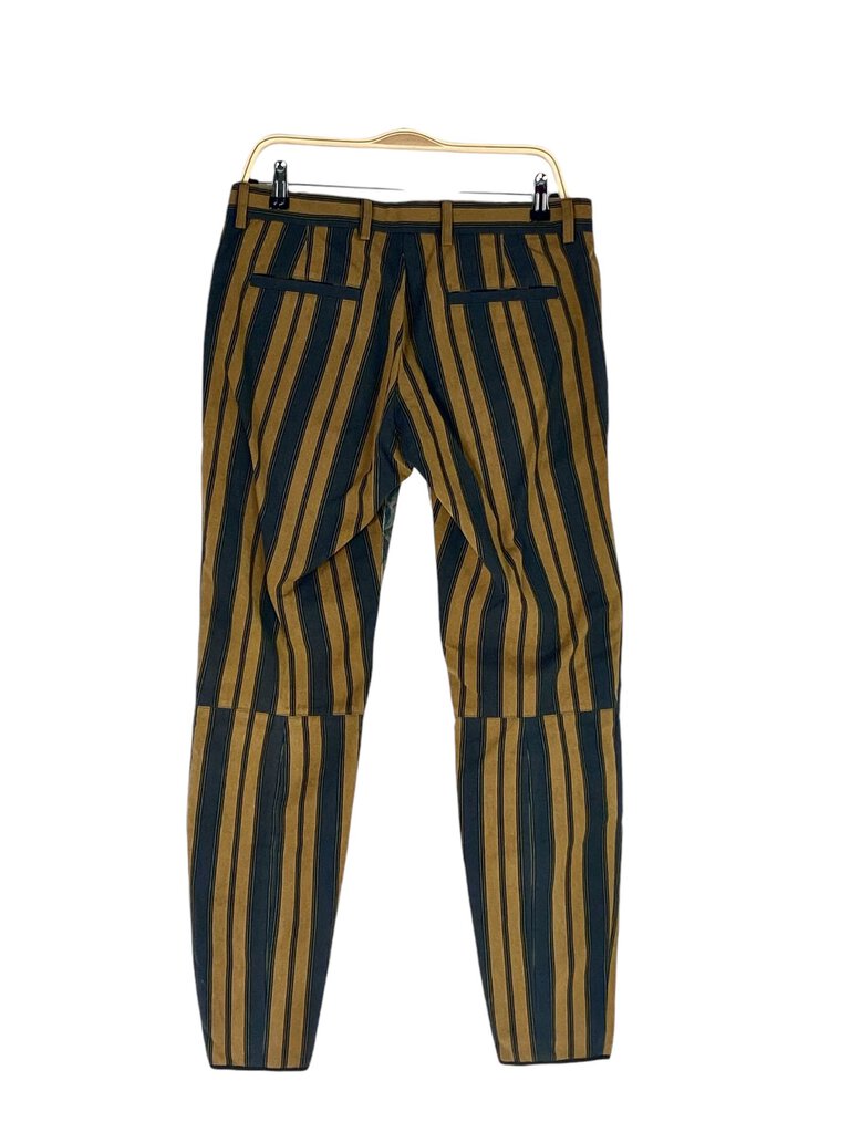 The Dries van Noten Floral Stripe Color Block Pants are a bold and artistic piece, showcasing a vibrant mix of floral patterns and striking color blocks. With their relaxed fit and unique design, these pants make a statement while offering versatility for both casual and dressed-up looks.