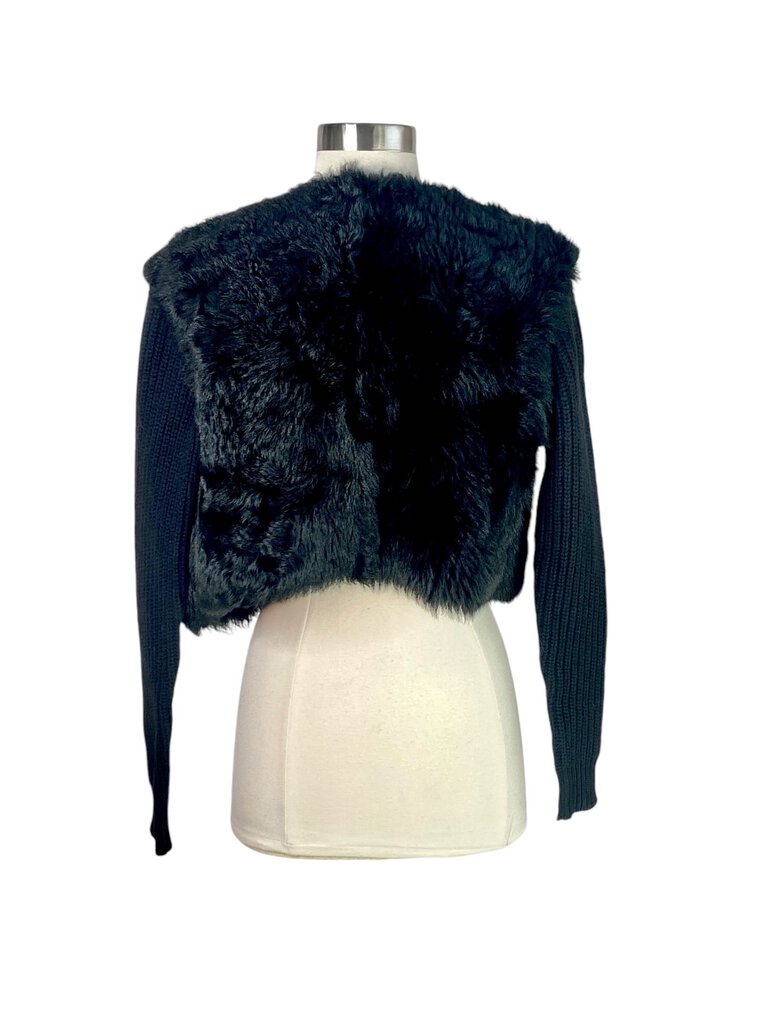 The Ralph Lauren Black Label Lamb Shearling and Wool Cropped Jacket is a luxurious outerwear piece that combines plush shearling with sleek wool for a sophisticated look. Its cropped silhouette and tailored fit make it an ideal choice for adding warmth and style to any ensemble, from casual to chic.