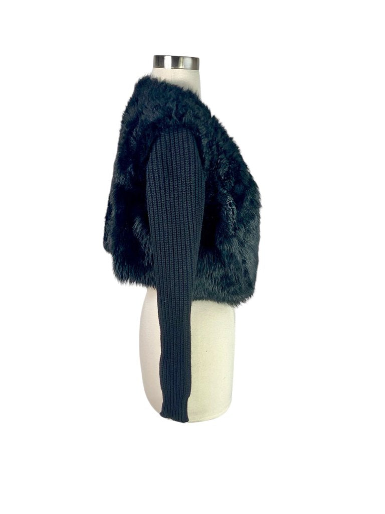 The Ralph Lauren Black Label Lamb Shearling and Wool Cropped Jacket is a luxurious outerwear piece that combines plush shearling with sleek wool for a sophisticated look. Its cropped silhouette and tailored fit make it an ideal choice for adding warmth and style to any ensemble, from casual to chic.