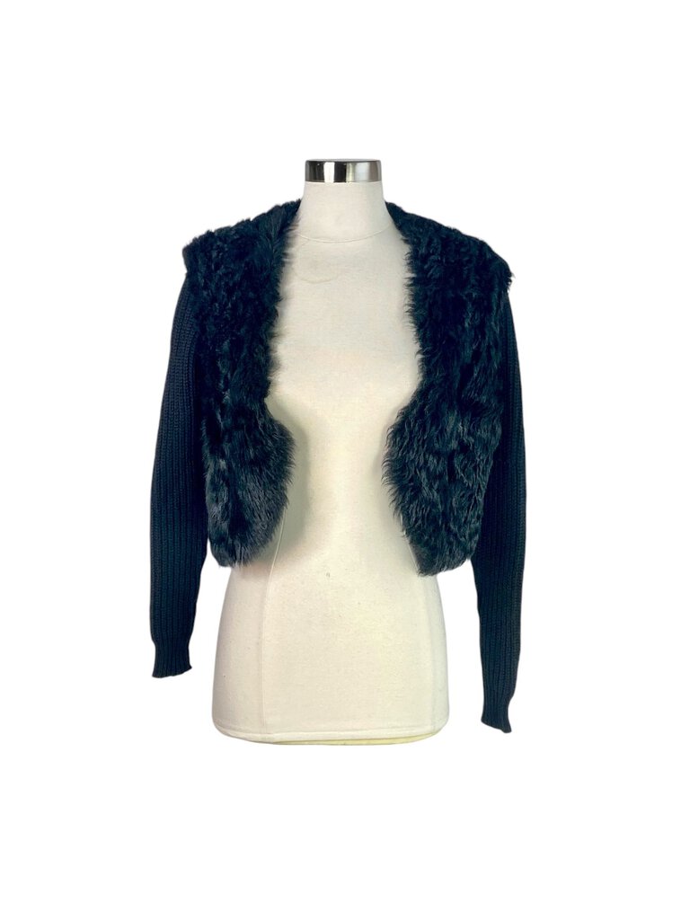 The Ralph Lauren Black Label Lamb Shearling and Wool Cropped Jacket is a luxurious outerwear piece that combines plush shearling with sleek wool for a sophisticated look. Its cropped silhouette and tailored fit make it an ideal choice for adding warmth and style to any ensemble, from casual to chic.