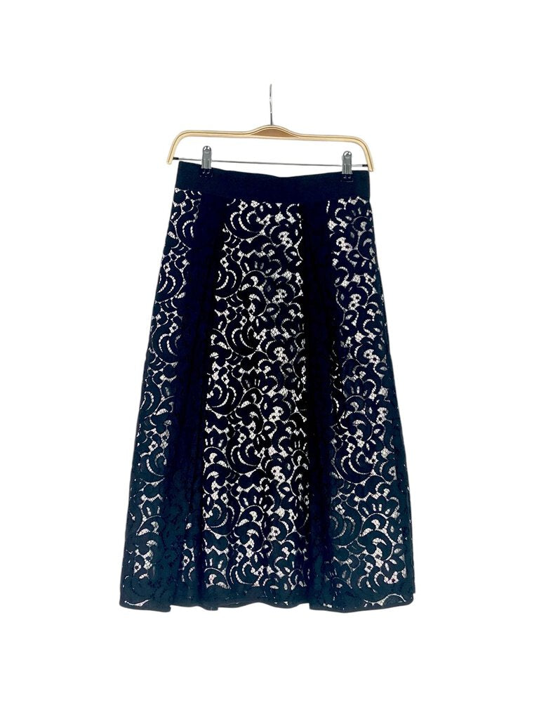 The Milly Lace Circle Skirt is a stunning piece that combines romantic lace with a flattering circular silhouette. Its intricate detailing and playful movement make it perfect for dressing up any outfit, adding a touch of sophistication to both casual and formal occasions.