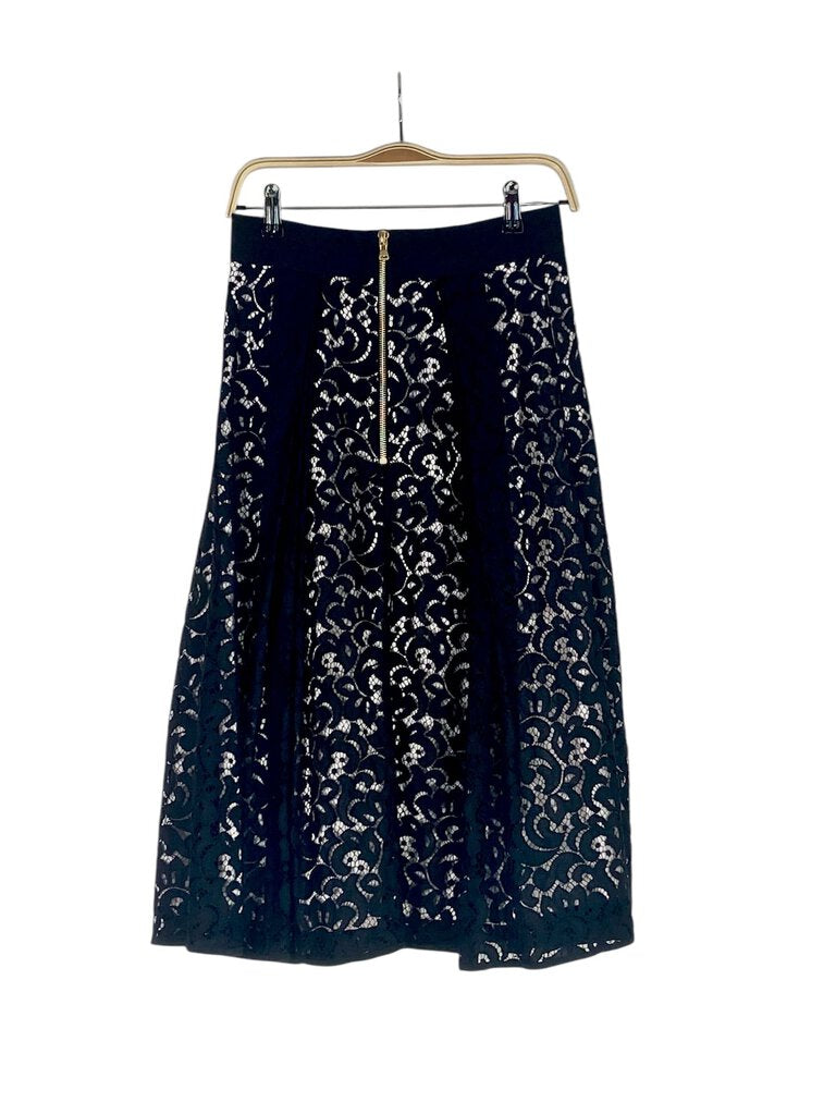 The Milly Lace Circle Skirt is a stunning piece that combines romantic lace with a flattering circular silhouette. Its intricate detailing and playful movement make it perfect for dressing up any outfit, adding a touch of sophistication to both casual and formal occasions.