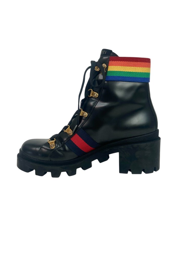 The Gucci 'Rainbow Trip' Combat Boots are a bold and playful footwear choice, featuring a vibrant color palette that adds a fun twist to the classic combat style. Crafted from high-quality materials, these boots combine comfort and edginess, making them perfect for elevating any casual outfit.