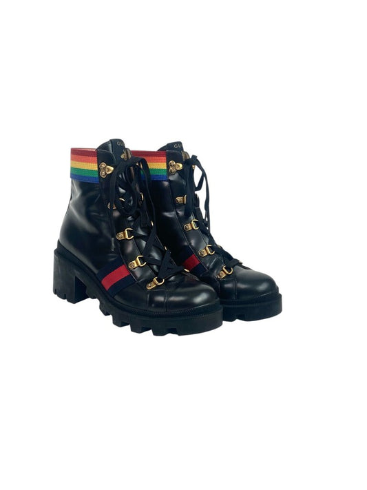 The Gucci 'Rainbow Trip' Combat Boots are a bold and playful footwear choice, featuring a vibrant color palette that adds a fun twist to the classic combat style. Crafted from high-quality materials, these boots combine comfort and edginess, making them perfect for elevating any casual outfit.