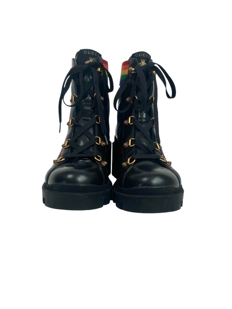 The Gucci 'Rainbow Trip' Combat Boots are a bold and playful footwear choice, featuring a vibrant color palette that adds a fun twist to the classic combat style. Crafted from high-quality materials, these boots combine comfort and edginess, making them perfect for elevating any casual outfit.