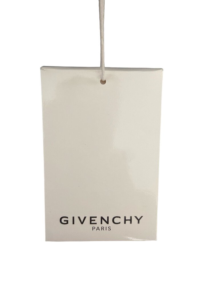 The Givenchy Travel Tote is a chic and spacious bag designed for stylish practicality, featuring the brand's signature logo and sleek lines. Crafted from durable materials, it effortlessly combines luxury with functionality, making it ideal for both travel and everyday use.