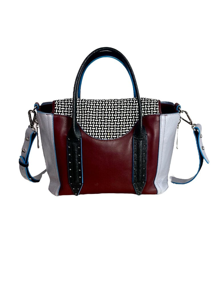 The Pour la Victoire Color Block Woven Handbag features a striking mix of vibrant hues and intricate woven detailing, creating a bold and stylish statement piece. With its structured silhouette and spacious interior, it seamlessly blends fashion and functionality for any occasion.