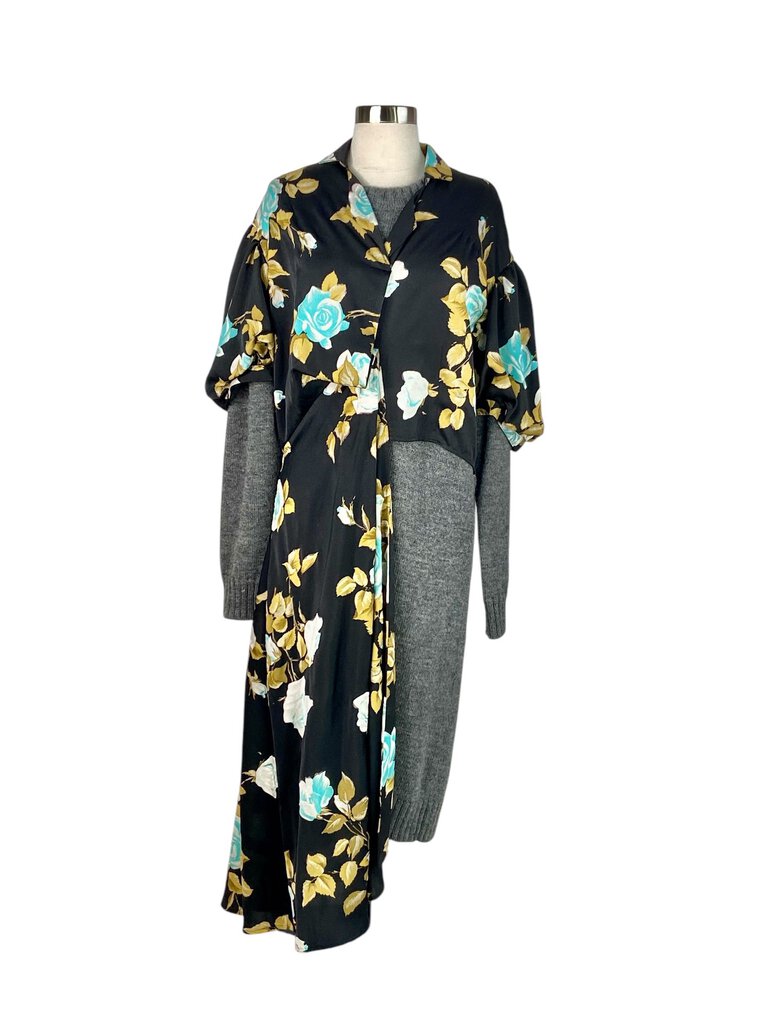 The Comme des Garçons Knit Contrast Floral Crepe Maxi Dress combines bold, contemporary design with a feminine flair, featuring a flowing crepe fabric adorned with vibrant floral patterns. The contrasting knit details add texture and dimension, creating a striking, avant-garde silhouette that's perfect for making a statement at any occasion.