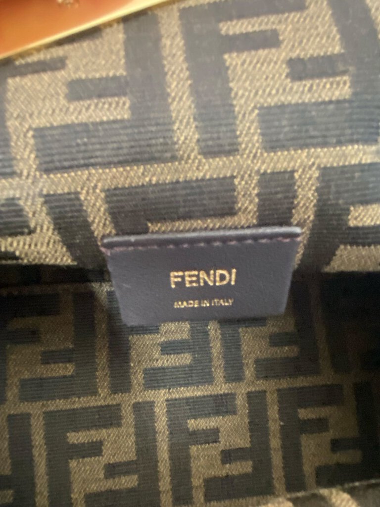 The Fendi First Shearling Bag is a luxurious and cozy handbag crafted from plush shearling, combining softness with high-fashion appeal. Its distinctive "F" clasp and sleek, compact silhouette make it a statement piece for both casual and evening looks.