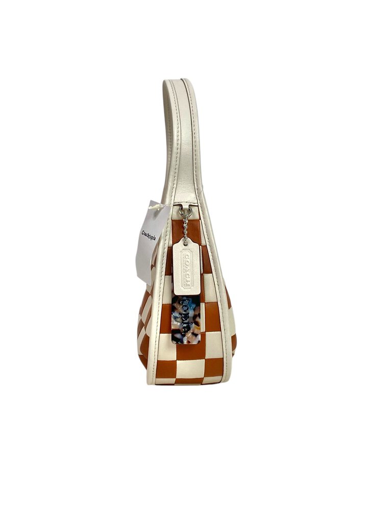 The Coachtopia Ergo Checkerboard Leather Bag is a bold, stylish handbag crafted from smooth leather featuring a striking checkerboard pattern. With its spacious interior and ergonomic design, it offers both fashion and functionality for everyday use.