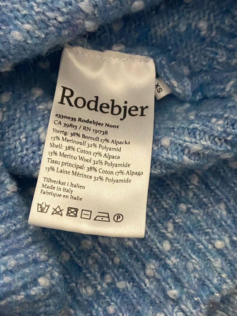 The Rodebjer Cropped Textured Sweater features a chic, contemporary design with a textured knit that adds depth and interest. Its cropped silhouette and relaxed fit make it a versatile, stylish piece perfect for layering or pairing with high-waisted pieces.